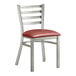 A Lancaster Table & Seating metal ladder back chair with a burgundy vinyl cushion.