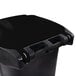 A black plastic Toter rectangular trash can with wheels and a locking lid.