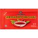 A red Kikkoman sriracha hot sauce packet.