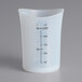 A translucent silicone iSi measuring cup with measurements on it.