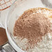 A bowl of flour and Guittard Sweet Ground Chocolate Powder.