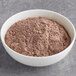 A bowl of Guittard Sweet Ground Chocolate Powder.
