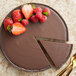 A chocolate cake with strawberries and mint made with Guittard Lever du Soleil Semi-Sweet chocolate.