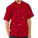 A man wearing a Uncommon Chef red short sleeve chef coat.