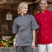 A man and woman wearing Uncommon Chef slate short sleeve chef coats.