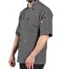 A man wearing a Uncommon Chef slate grey short sleeve chef coat.
