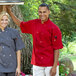 A man and woman wearing Uncommon Chef short sleeve chef jackets in red.