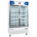 A white Avantco merchandising refrigerator with glass doors and shelves.