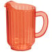 An orange plastic beverage pitcher with a handle.