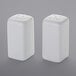 Two white ceramic square salt and pepper shakers.