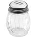 A clear Lexan plastic spice shaker with a metal top.