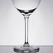 A close-up of a Libbey wine glass with a white rim.