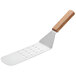 A Vollrath perforated stainless steel turner with a wooden handle.