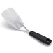 An OXO stainless steel spatula with a black handle and hole.