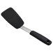 An OXO black silicone spatula with a silver handle.