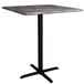 A Lancaster Table & Seating square bar height table with a black base and a smooth marble top.