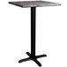 A Lancaster Table & Seating square counter height table with a black base and gray top.