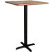 A Lancaster Table & Seating square bar table with a textured Yukon oak finish and black cross base plate.