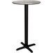 A round Lancaster Table & Seating bar table with a black base.