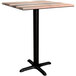 A Lancaster Table & Seating Excalibur square wooden table with a black base.