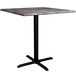A Lancaster Table & Seating square counter height table with a black base and gray marble top.