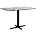 A rectangular white table with a smooth finish and black cross base plate.