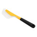 An OXO yellow and black silicone flexible omelet spatula with a yellow handle.