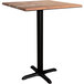 A Lancaster Table & Seating square counter height table with a textured Yukon Oak finish and a black cross base.