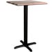 A Lancaster Table & Seating Excalibur square counter height table with a black base and wood textured mixed plank top.