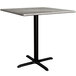 A Lancaster Table & Seating Excalibur square counter height table with a black base and a textured gray top.