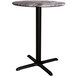A Lancaster Table & Seating round counter height table with a black base.