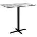A white marble Lancaster Table & Seating bar table with a black base.