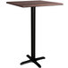 A Lancaster Table & Seating square bar height table with a textured walnut top and black cross base.
