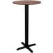 A round brown Lancaster Table & Seating bar height table with a cross base plate.