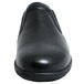 A Genuine Grip black leather slip-on women's shoe with a rubber sole.
