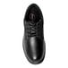 A close-up of a Genuine Grip men's black leather oxford shoe with laces.