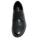A Genuine Grip black leather shoe with laces.
