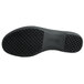 The black sole of a Genuine Grip black leather shoe.
