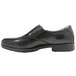 A black Genuine Grip men's slip-on dress shoe with a rubber sole.