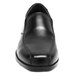 A close-up of a black Genuine Grip slip-on dress shoe.