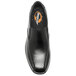 A close-up of a black Genuine Grip slip-on dress shoe with an orange sole.