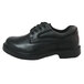 A close up of a Genuine Grip black leather oxford shoe with laces and a rubber sole.