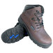 A pair of brown Genuine Grip work boots with blue laces.