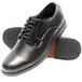 A pair of black leather Genuine Grip men's oxford shoes with rubber soles.