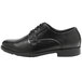 A black Genuine Grip men's oxford dress shoe with laces.