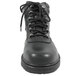 A black leather Genuine Grip steel toe boot with a zipper lock.
