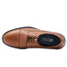 A brown Shoes For Crews Senator men's dress shoe with laces and a black sole.