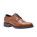A brown leather Shoes For Crews Senator dress shoe with a black sole.