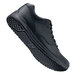 A black Shoes For Crews Liberty women's athletic shoe with white laces and red soles.