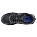 A black Shoes For Crews Energy II athletic shoe with blue laces and a blue sole.